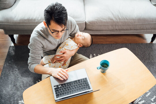 father and baby at home