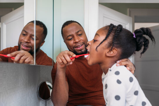 A Man and His Little Daughter in the Bathroom 