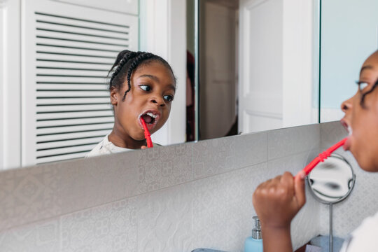 A Little Girl Brushing Her Teeth