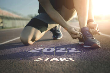 2022 symbolises the start into the new year.Start of people running on street,with sunset light.Goal of Success