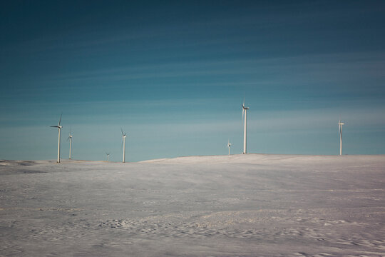 Windmills on the prairies during winter.