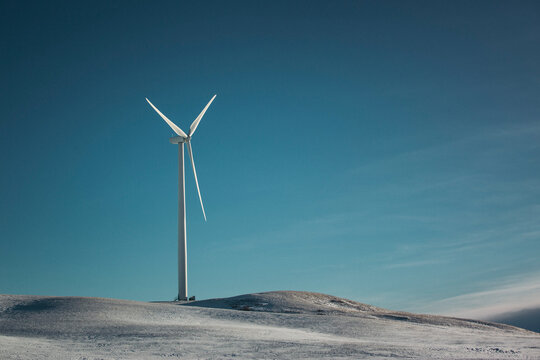Windmills on the prairies during winter.