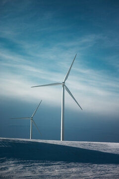 Windmills on the prairies during winter.
