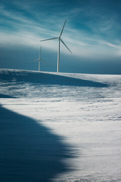 Windmills on the prairies during winter.