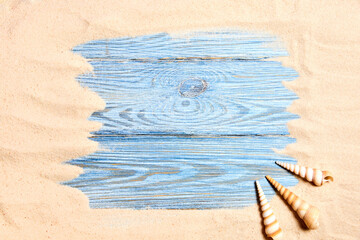 Fototapeta na wymiar Summer background from sea sand with seashells on blue wooden planks. Top view with copy space