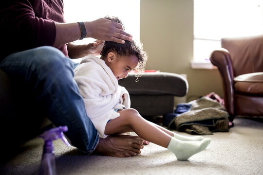 Father fixes daughter's curly hair