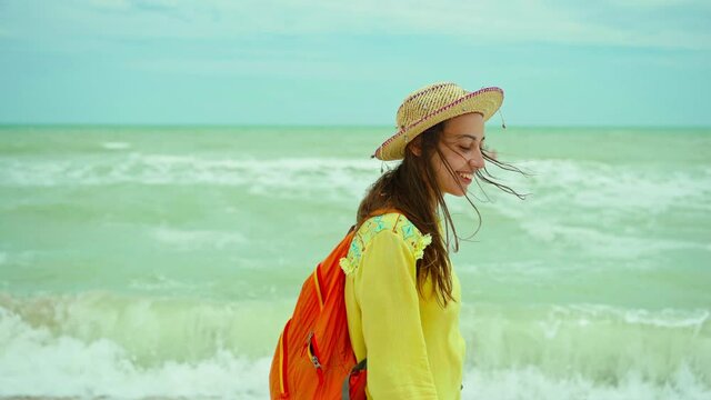 Authenticity portrait happy young woman in straw hat wearing yellow shirt having fun and feeling happiness during walking on beach