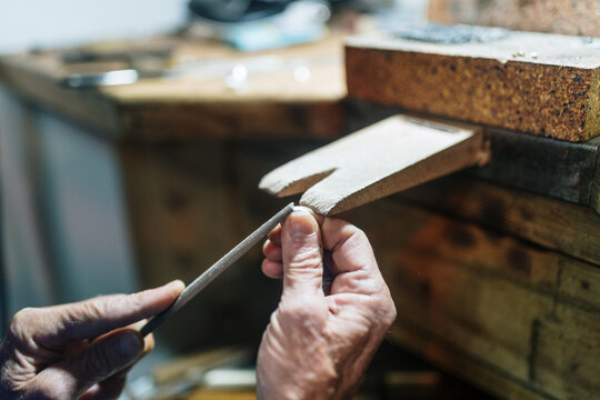 Old jeweler working on a workshop