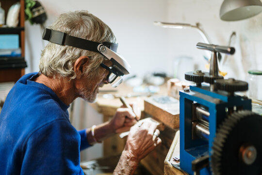 Old jeweler working on a ring