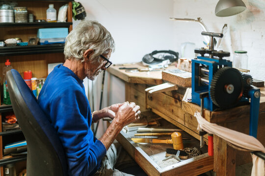 Old jeweler working on a ring