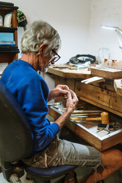 Old jeweler working on a ring