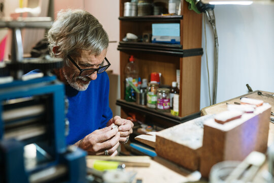 Old jeweler working on a ring