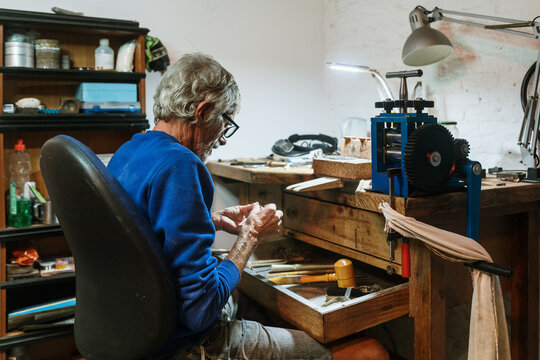 Old jeweler working on a ring