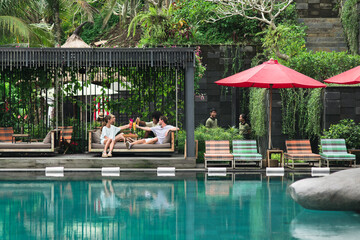 friends relaxing by the pool in the resort