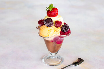 Ice cream in glass bowl. Milk, chocolate, cherry, melon and caramel ice cream.