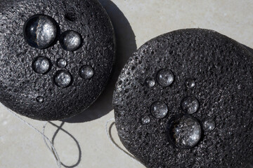 Bamboo charcoal sponge close up with water drops. Face Cleansing and Make Up Removing Beauty Routine