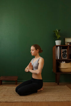 Young female meditating at home