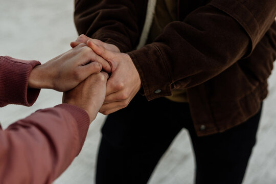 Close-up of young couple holding hands