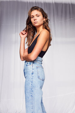 Young woman in stylish jeans and black top