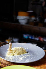 breaded chicken thigh on a plate on the background of the kitchen