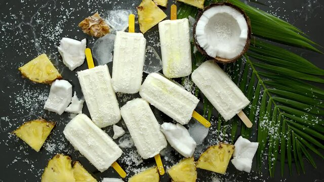 Summer popsicles on stick. Pinacolada flavour. Made with pineapple, cocount milk, rum. Vegan snack