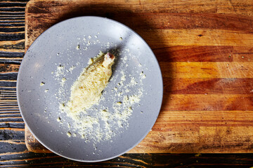 breaded chicken thigh on a plate on the background of the kitchen