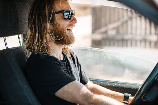 Man with sun bleached hair driving