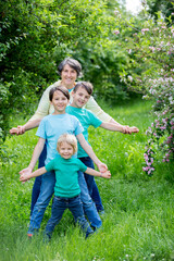 Fototapeta premium Grandmother and grandchildren, playing together in the park