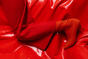 red boots on red shiny fabric