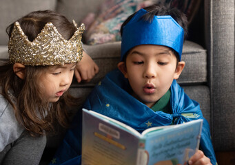 Kids reading exciting book together