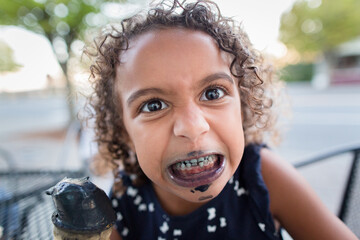 Girl eating black licorice icecream
