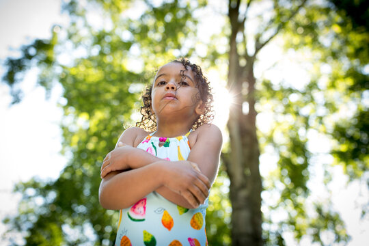 Low angle view of shivering girl in swimsuit