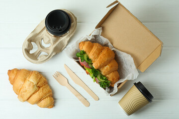 Concept of tasty eating with croissant sandwich, top view