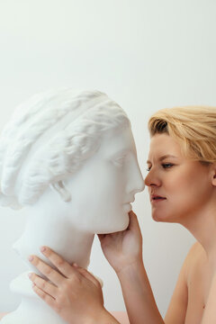 Androgynous woman and statue