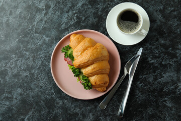Concept of tasty eating with croissant sandwich, top view