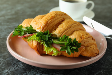 Concept of tasty eating with croissant sandwich, close up