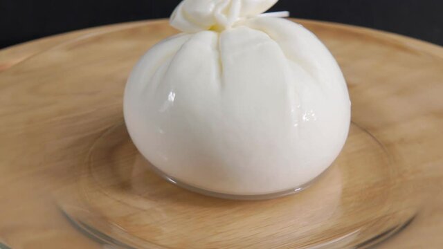 Italian Buratto cheese close up. The concept of healthy Mediterranean food