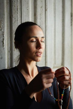 Woman doing a prayer.