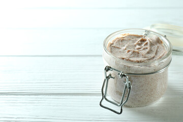 Skin care scrub on white wooden background