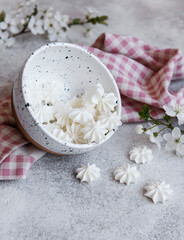 Small white meringues in the  ceramic bowl