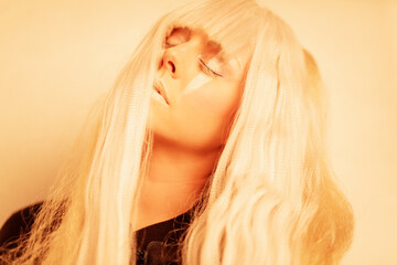 Futurist  portrait of a beautiful woman closing  eyes with yellow light 