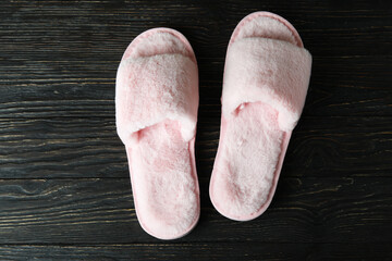Pair of house slippers on wooden background