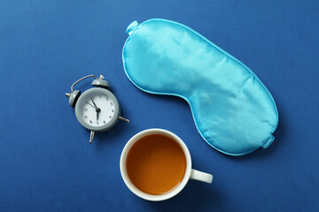 Different sleep routine accessories on blue background