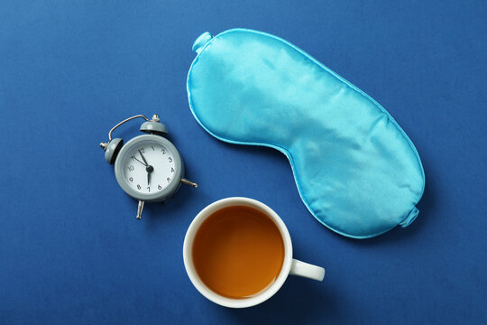 Different sleep routine accessories on blue background