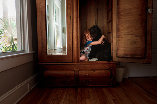 A child plays with her dog