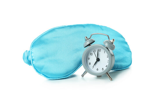 Sleep mask and alarm clock isolated on white background