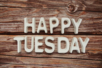 Happy Tuesday text message on wooden background