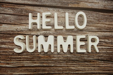 Hello Summer text message on wooden background