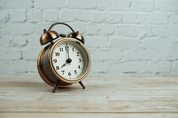 Vintage alarm clock with space copy on wooden background
