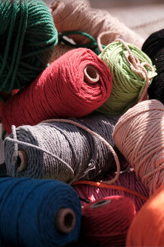 Closeup of colorful cotton rope thread on wooden table. Used to weave mandala totem